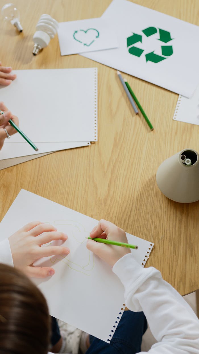 gallery-1 Kids drawing eco-friendly symbols, promoting recycling and sustainability.
